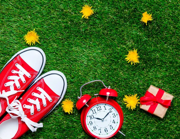 Alarm clock and red gumshoes — Stock Photo, Image