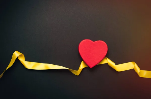 Red heart with yellow ribbon — Stock Photo, Image
