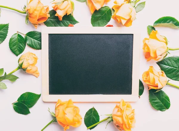 Yellow roses and black board — Stock Photo, Image