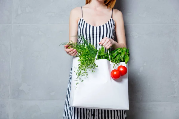 Nő gazdaság táska zöldségekkel — Stock Fotó