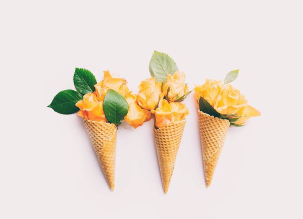 Yellow roses in waffle cones