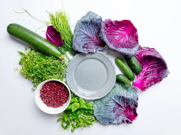 Herbs and vegetables with plate — Stock Photo, Image