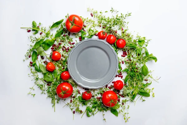 Herbs and tomatoes and plate — Stock Photo, Image