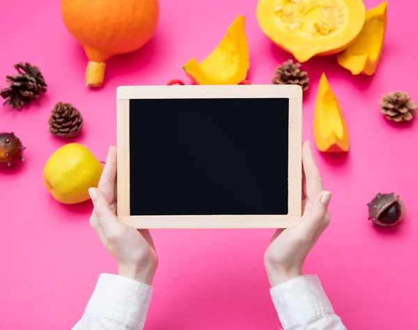 Female hands holding blank blackboard — Stock Photo, Image