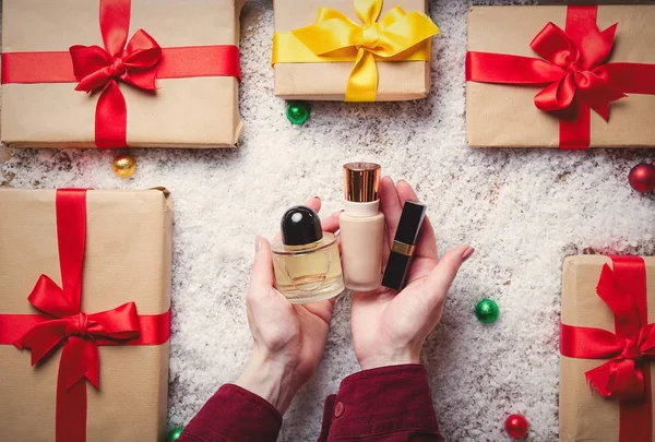 Woman holding cosmetics — Stock Photo, Image