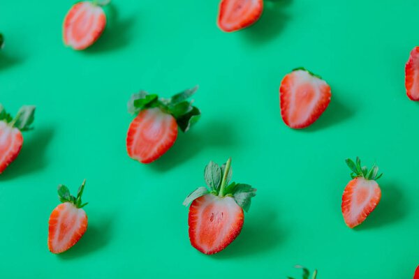 Strawberries  on green background.