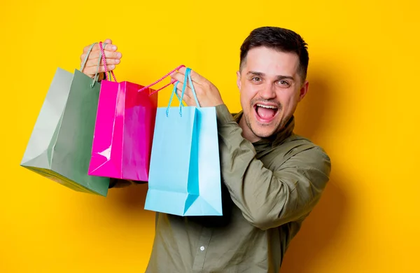 Young Happy Man Colorful Shopping Bags Yellow Background — Stock Photo, Image