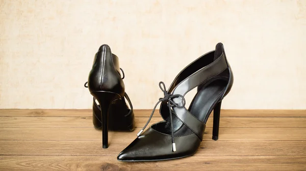 Black high heel shoes on wooden background Royalty Free Stock Images