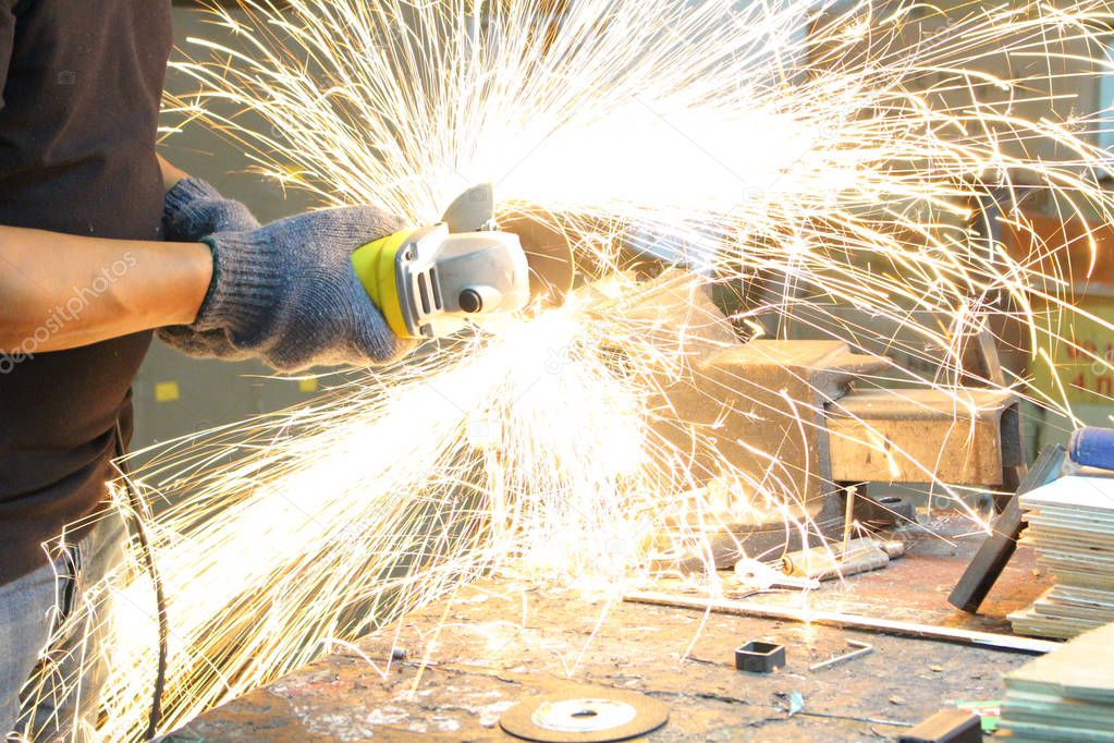 Cutting metal with angle grinder.