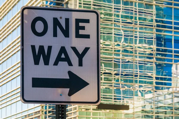 Road sign "One way" on the background of office building — Stock Photo, Image