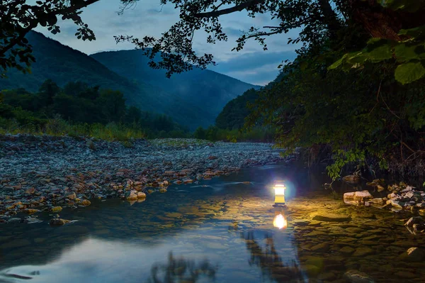 Hand lantern in Makopse river at twilight — Stock Photo, Image