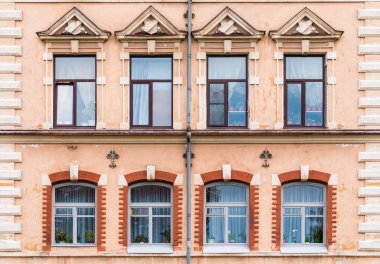 Windows in row on facade of historic building clipart