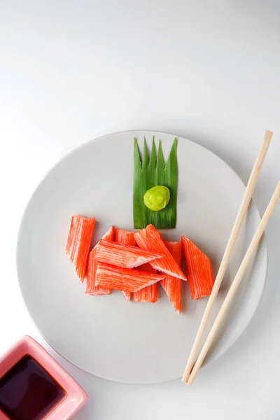 Imitation Crab Stick on a plate on white background — Stock Photo, Image