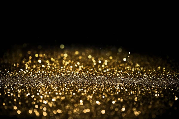 Kopya alanı siyah bir zemin üzerine altın tozu serpin — Stok fotoğraf