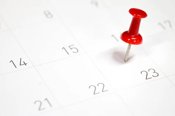 Embroidered red pins on a calendar on the 23rd with selective focus — Stock Photo, Image