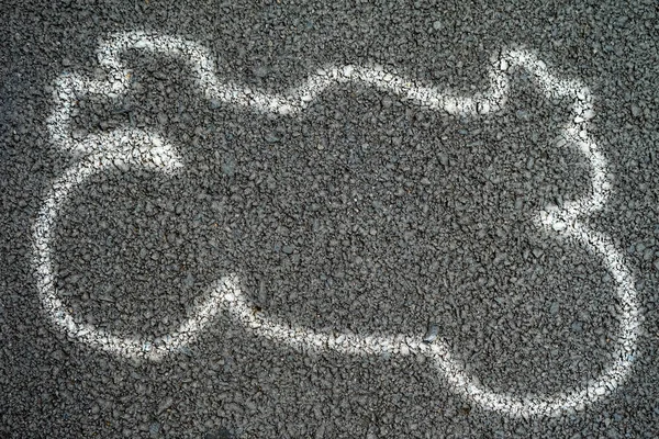 White outline of motorcycle at the accident on the Road