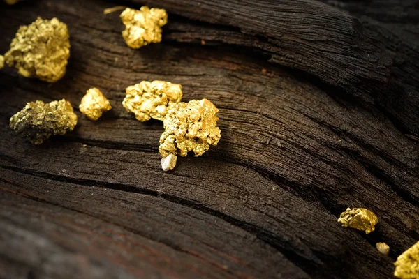 Pure gold ore on old wooden floor