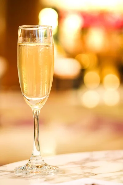 Sparkling Wine Glass or champagne on Marble Table On the background blurred