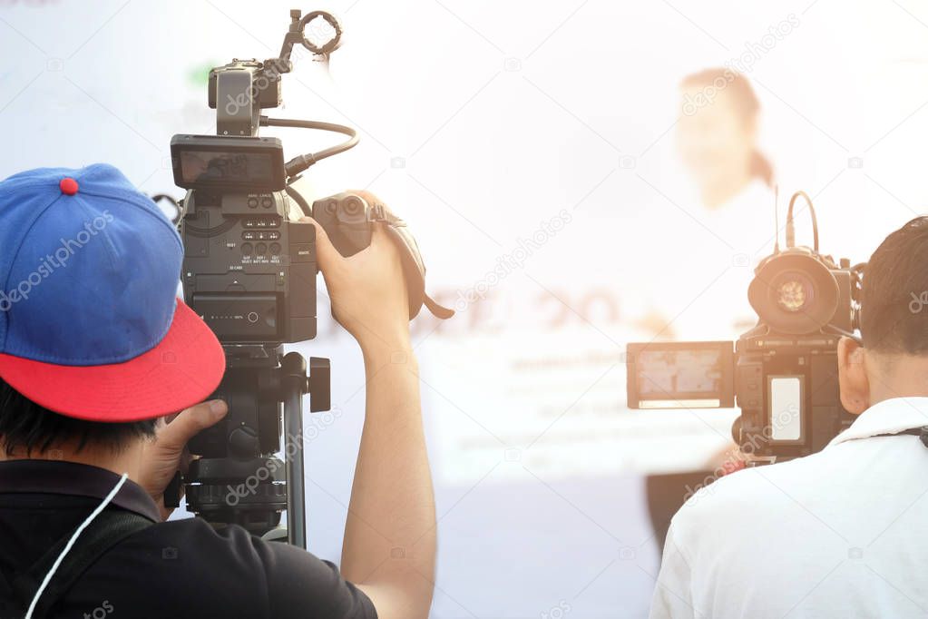 Photographer video recording activity within the event