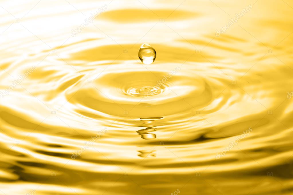 Liquid gold drop and ripple ,abstract background