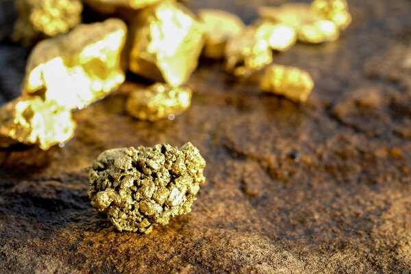 The pure gold ore found in the mine on a stone floor