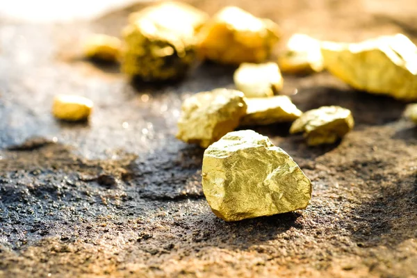 The pure gold ore found in the mine on a stone floor