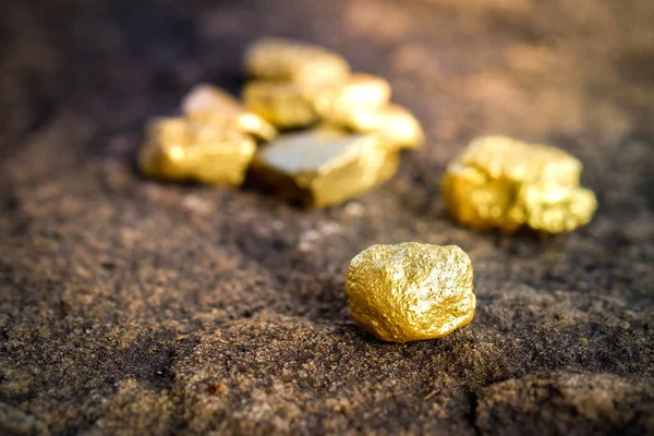 The pure gold ore found in the mine on a stone floor