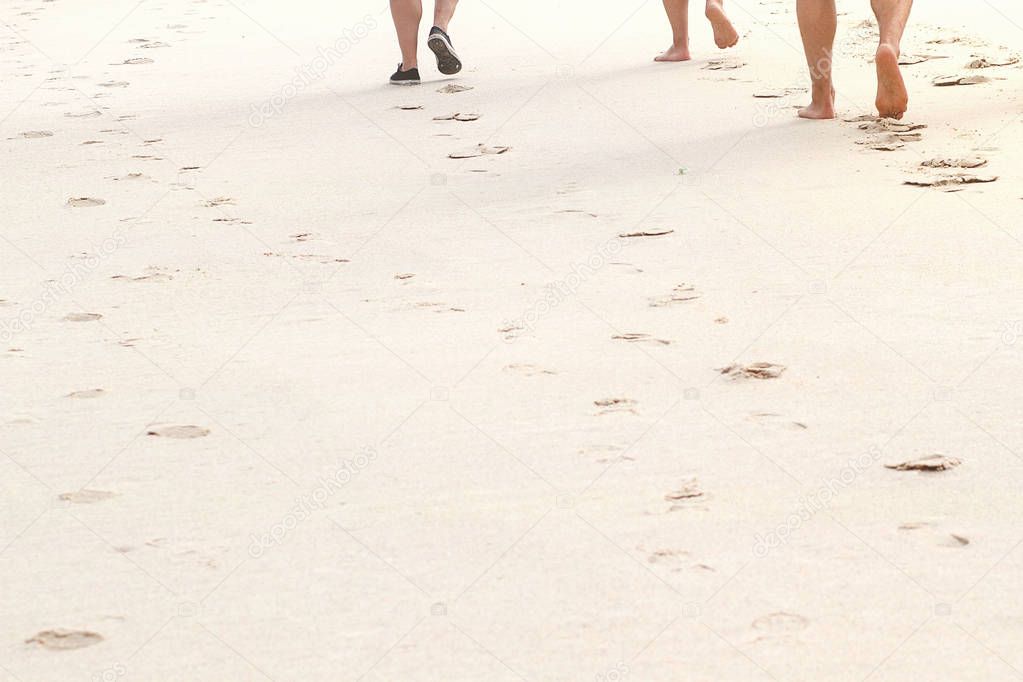 Barefoot beach walking closeup