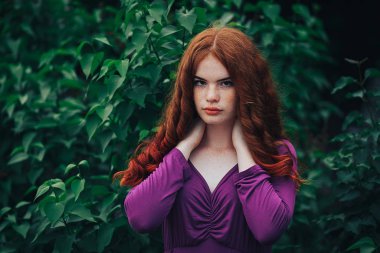 girl in a dress among lilacs