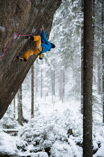 Rock climber, professional athlete, climbing in Karelian mountains. Extreme sports.