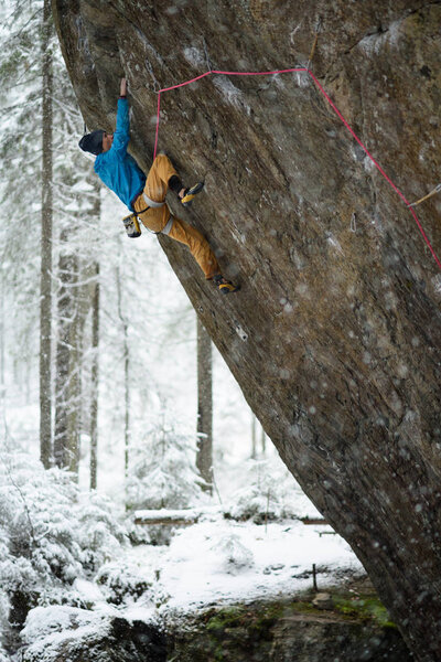 Outdoor sport. Rock climber ascending a challenging cliff. Extreme sport climbing. 