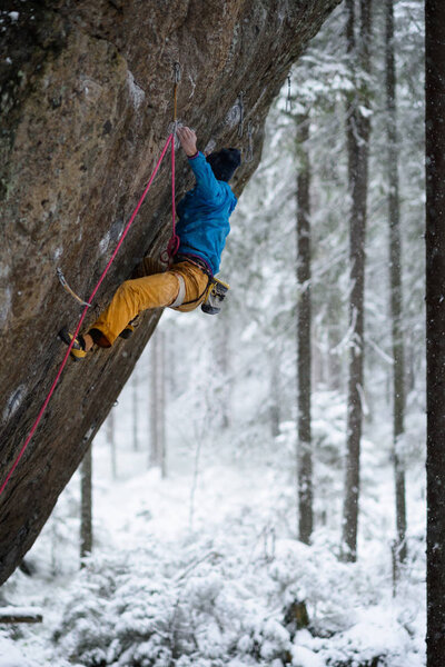 Rock climber, professional athlete, climbing in Karelian mountains. Extreme sports. 