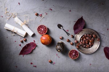 Natürmort ayrıntıları, kağıt kayar, fındık ve portakal, retro vintage. Romantik aşk mektubu veya gri arka plan üzerinde düğün davetiyeleri. Üstten Görünüm.