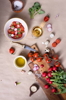 Akdeniz domates salatası marul yaprakları ve turp ahşap kesme tahtası üzerinde karışımı ile. İtalyan mutfağı, yakın çekim, üstten görünüm.
