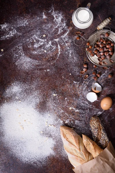 Preparazione della pasta. Ingredienti di cottura: uovo, farina, latte, noci su un tavolo rustico. baguette di pane appena sfornate. Posa piatta, spazio di copia . — Foto Stock