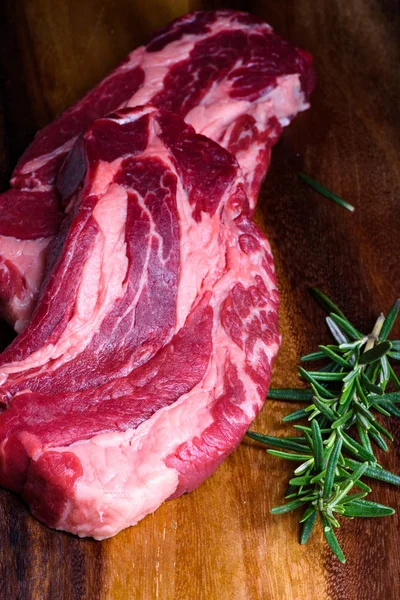 Çiğ et, sığır eti biftek ahşap cutboard, baharatlar, üstten görünüm — Stok fotoğraf