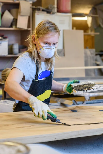 Handy woman in a work uniform working at the factory or workshop. The concept of women\'s equality and feminism. Female carpenter.