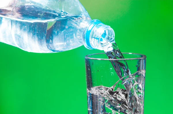 water bottle with splash and clear glass