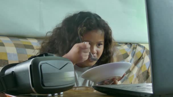 Medio primo piano di una multiculturale ragazza asiatica guardando un video mentre si mangia tagliatelle — Video Stock