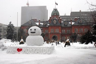 snowman and building in hokkaido clipart
