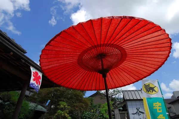 Red umbrella on street — Stock Photo, Image