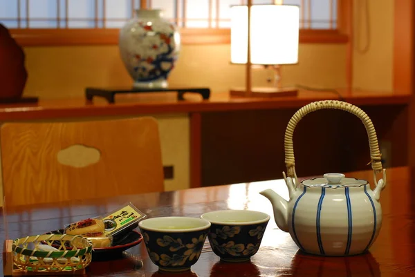 Cups and teapot on table — Stock Photo, Image