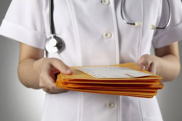 Doctor sosteniendo documentos en las manos — Foto de Stock