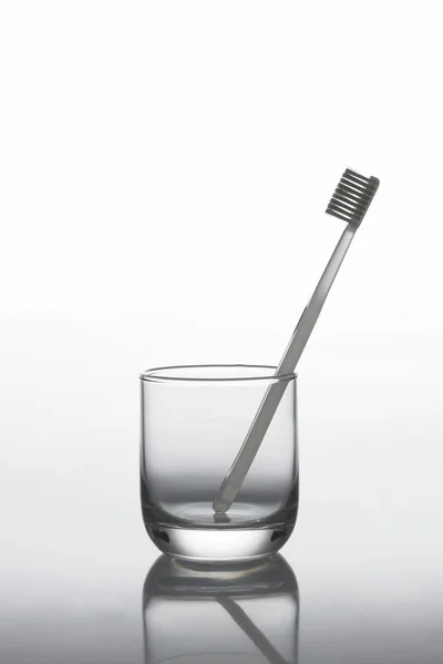 Toothbrush in glass cup — Stock Photo, Image