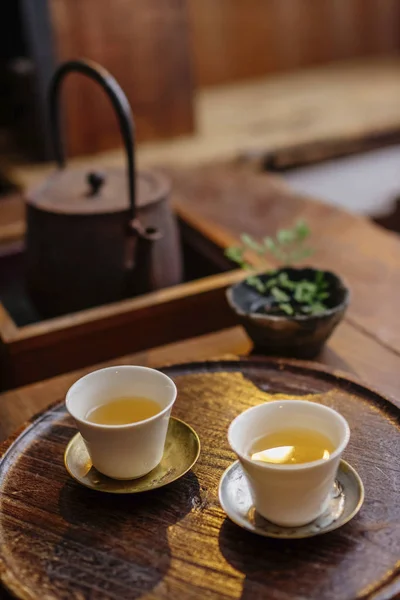 Tea cups on wooden board — Stock Photo, Image