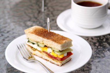 Dilimlenmiş etli sandviç tablo ile beyaz plaka closeup 