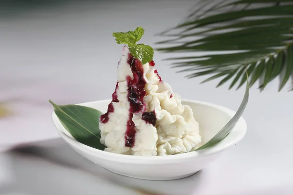 mashed chinese yam with blueberry syrup, close-up view