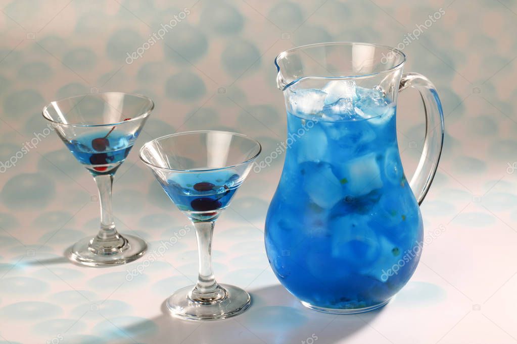 Closeup of restaurant blue iced tea set over cyan-dotted background
