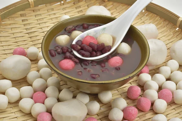 sweet dumplings with beans served in bowl with spoon