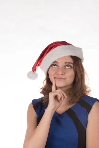 Дівчина в червоному різдвяному капелюсі з різними кумедними емоціями на його — стокове фото
